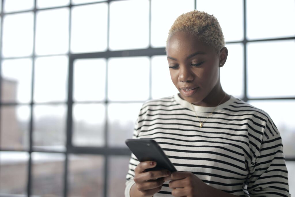 A person looking at their phone to get information about low THC oil in Georgia. 